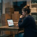 Small business owner reviewing falling ad results on a laptop in her shop, illustrating why Indian businesses fail at marketing